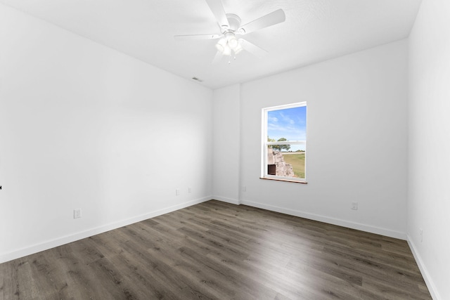 unfurnished room with dark hardwood / wood-style floors and ceiling fan