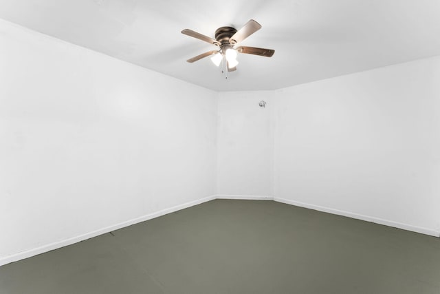 spare room featuring ceiling fan and concrete flooring