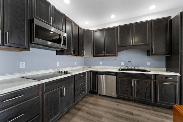 kitchen with wood-type flooring, dark brown cabinets, sink, and stainless steel appliances