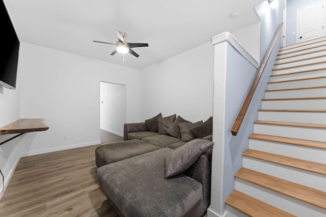 living room featuring hardwood / wood-style floors and ceiling fan