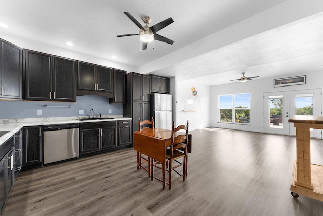 kitchen with ceiling fan, wood-type flooring, sink, stainless steel appliances, and french doors