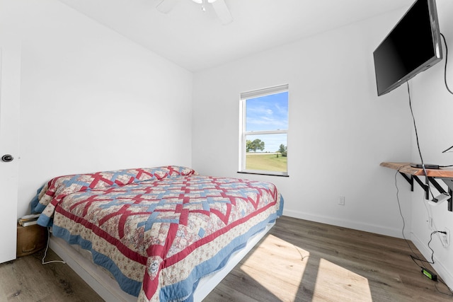 bedroom featuring ceiling fan and dark wood-type flooring