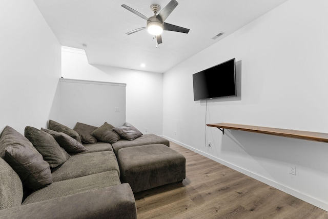 living room featuring wood-type flooring and ceiling fan