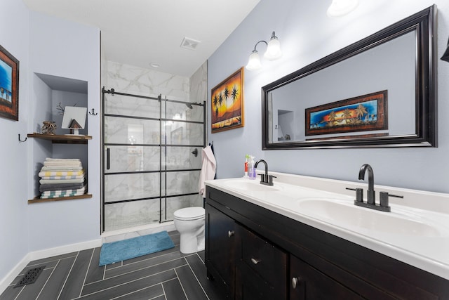 bathroom with walk in shower, tile patterned floors, vanity, and toilet