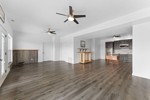 unfurnished living room with ceiling fan and dark hardwood / wood-style floors