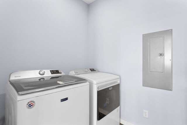 laundry room featuring electric panel and washer and dryer