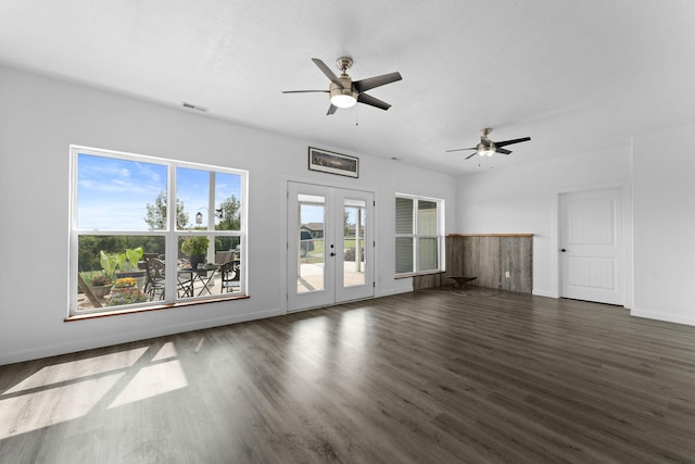 unfurnished living room with dark wood-type flooring, a wealth of natural light, and ceiling fan