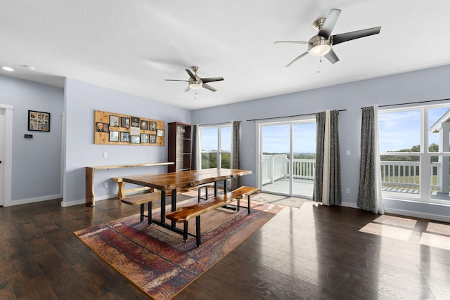 dining space with ceiling fan, a wealth of natural light, dark wood-type flooring, and a textured ceiling