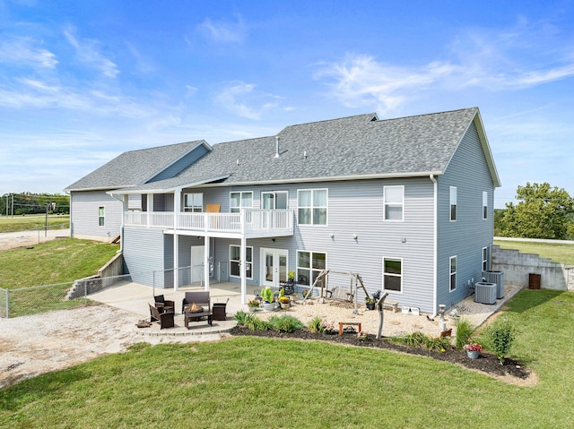 back of property featuring an outdoor living space, a balcony, a lawn, a patio area, and cooling unit