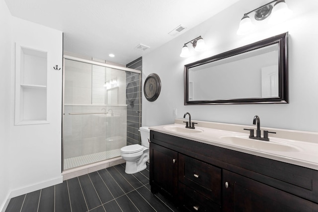 bathroom featuring vanity, walk in shower, and toilet