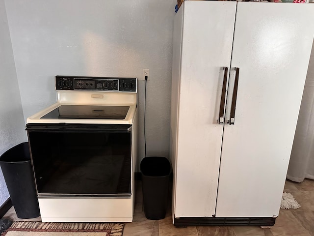 interior details featuring white appliances and white cabinetry