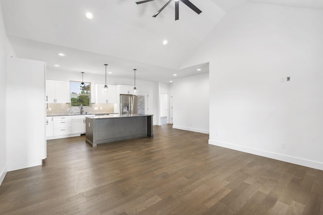 kitchen featuring a kitchen island, dark hardwood / wood-style floors, stainless steel fridge, decorative light fixtures, and white cabinets