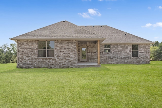 rear view of property with a patio area and a yard