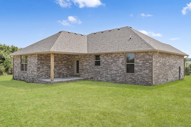 back of property featuring a yard and a patio