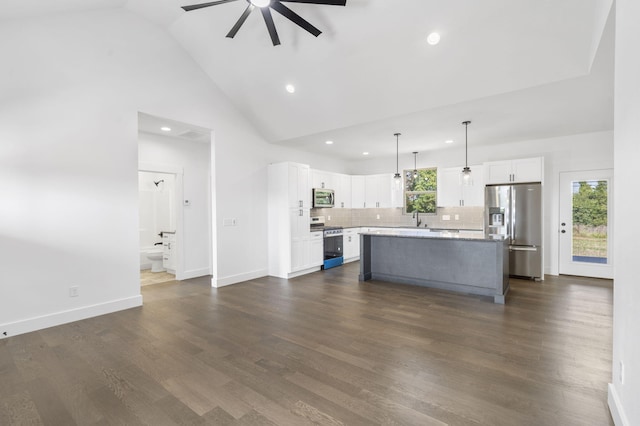 kitchen with white cabinets, a center island, dark wood-type flooring, and appliances with stainless steel finishes