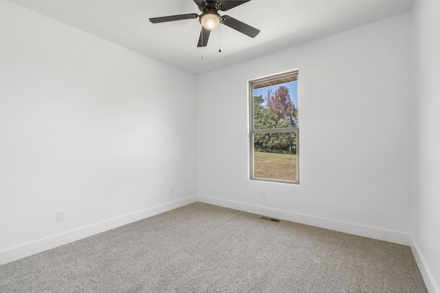 empty room featuring carpet flooring and ceiling fan