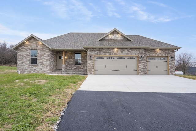 view of front of home with a front yard and a garage