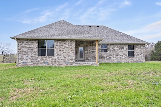 back of property featuring a yard and a patio