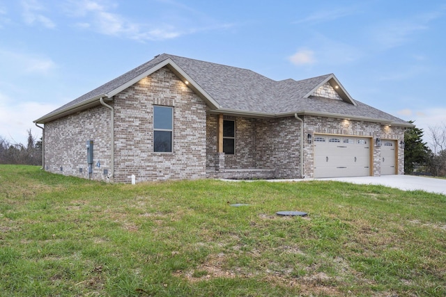 view of front of house with a front yard and a garage