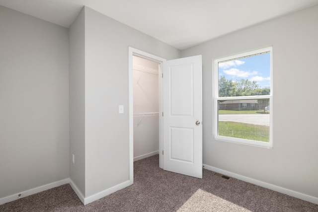 unfurnished bedroom featuring a closet and carpet