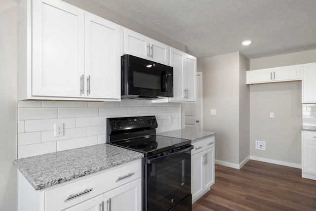 kitchen with dark wood-type flooring, backsplash, white cabinetry, and black appliances