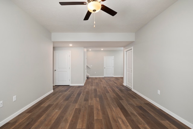 empty room with dark hardwood / wood-style flooring, a textured ceiling, and ceiling fan