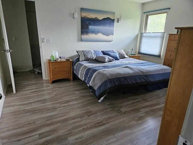 bedroom with dark hardwood / wood-style flooring