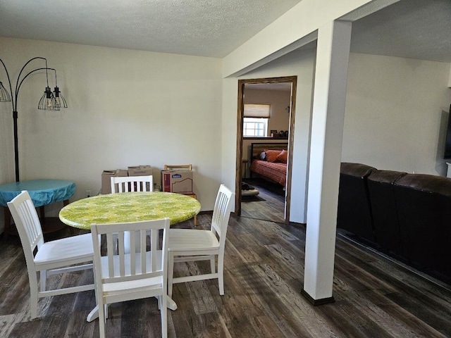 dining room featuring dark hardwood / wood-style floors and a textured ceiling