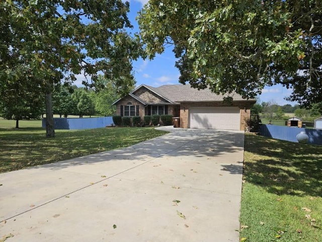 view of front of house with a front yard and a garage