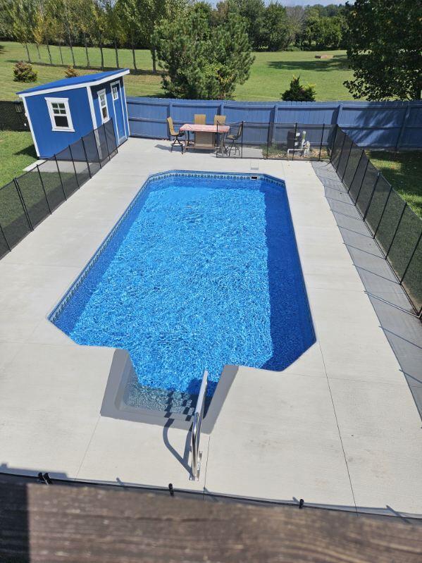 view of pool featuring a patio and a lawn