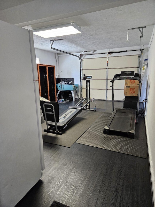 exercise room featuring hardwood / wood-style flooring and a textured ceiling