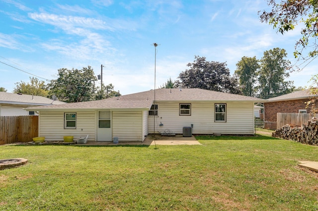 back of house featuring a lawn, a patio, and central air condition unit