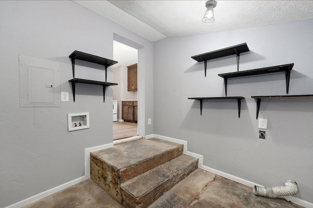 staircase with concrete floors, electric panel, vaulted ceiling, and a textured ceiling