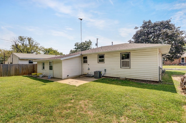 back of property featuring a patio, a lawn, and central AC unit