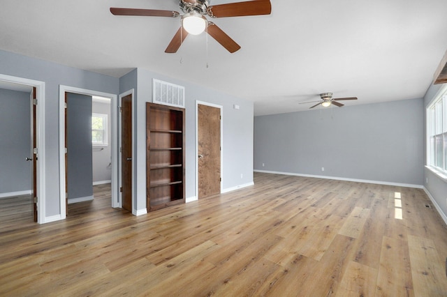 unfurnished living room with ceiling fan and light hardwood / wood-style floors