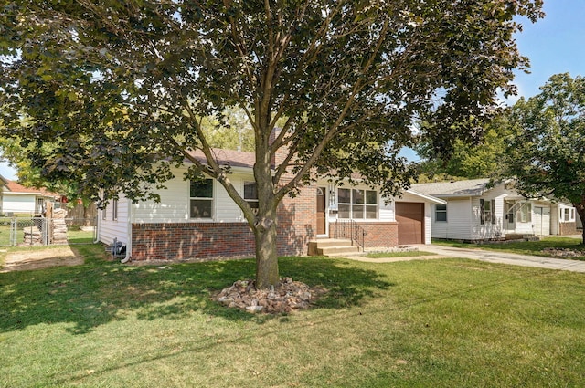 view of property hidden behind natural elements with a front yard