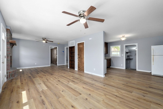 unfurnished living room featuring light wood-type flooring, a fireplace, and ceiling fan