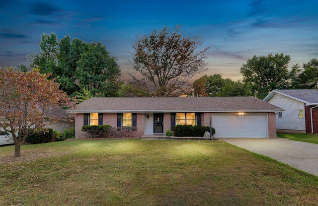 single story home with a yard and a garage