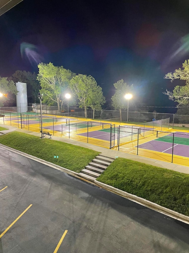 view of sport court featuring a lawn