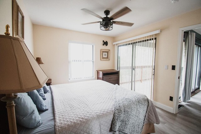 11863 State Highway 13 Unit 160, Kimberling City, MO 65686 - bedroom with wood finished floors, a ceiling fan, baseboards, and multiple windows