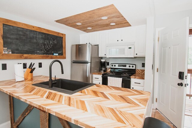 11863 State Highway 13 Unit 160, Kimberling City, MO 65686 - kitchen featuring white cabinets, stainless steel appliances, butcher block countertops, and a sink