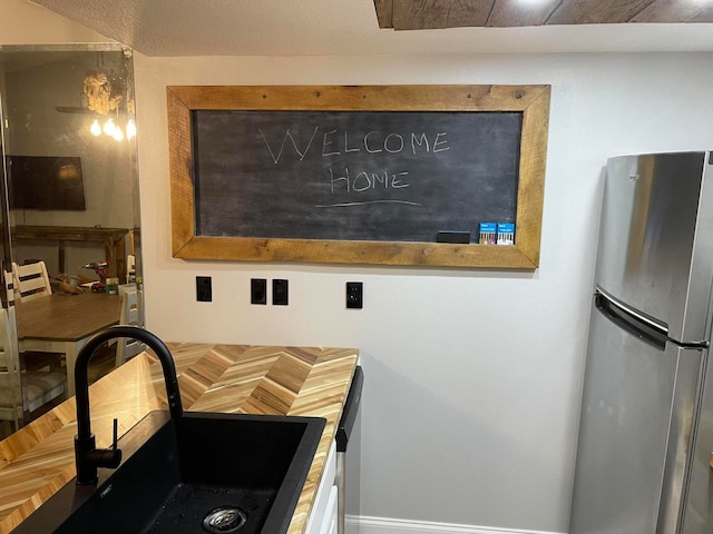 kitchen with stainless steel refrigerator and sink