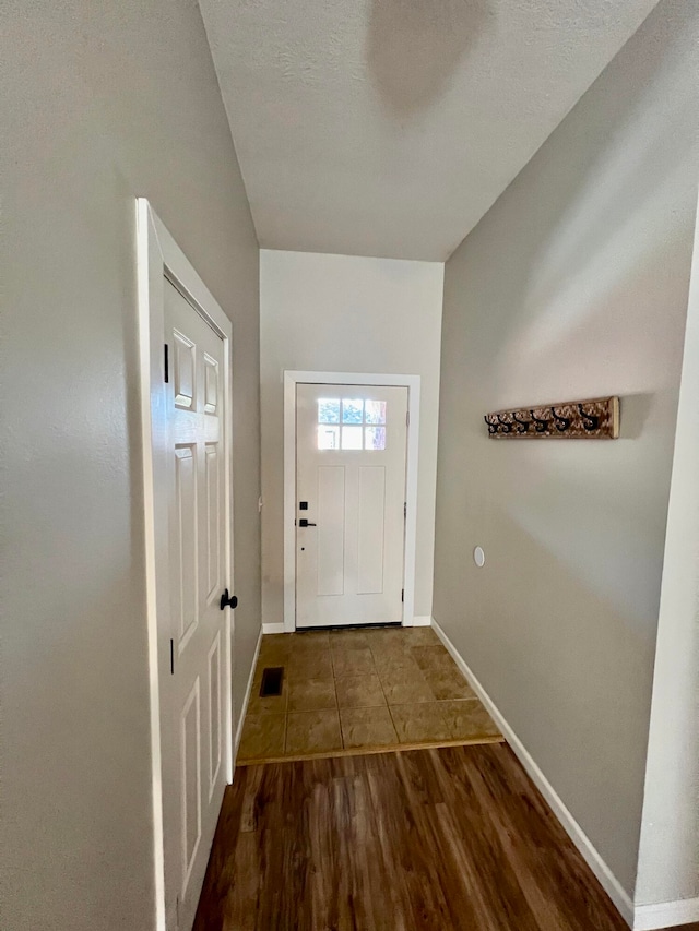 entryway featuring hardwood / wood-style floors and a textured ceiling