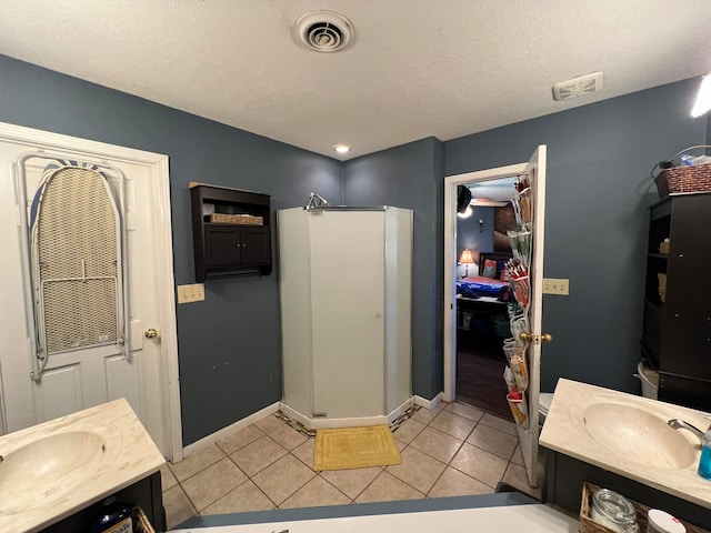 bathroom featuring vanity, a textured ceiling, and tile patterned floors