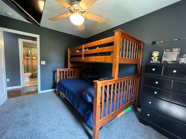 bedroom with carpet floors, connected bathroom, and ceiling fan