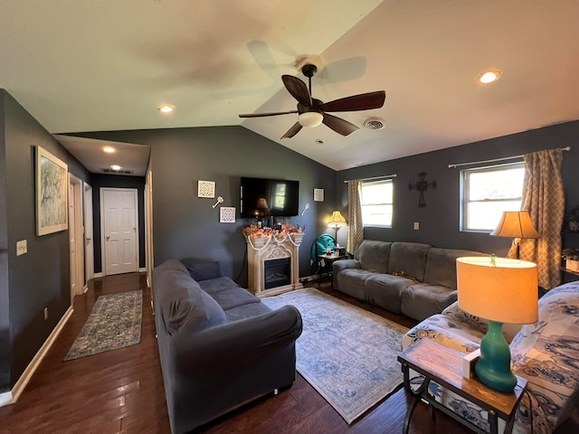 living room with lofted ceiling, dark hardwood / wood-style flooring, and ceiling fan