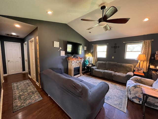 living room with dark hardwood / wood-style floors, vaulted ceiling, and ceiling fan