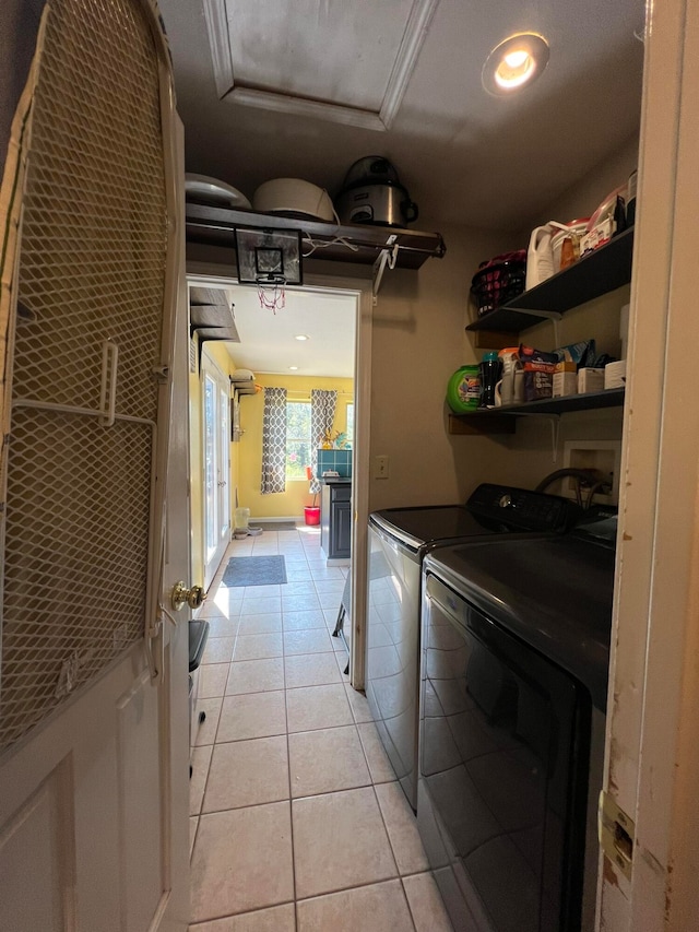 interior space featuring light tile patterned flooring and washer and dryer