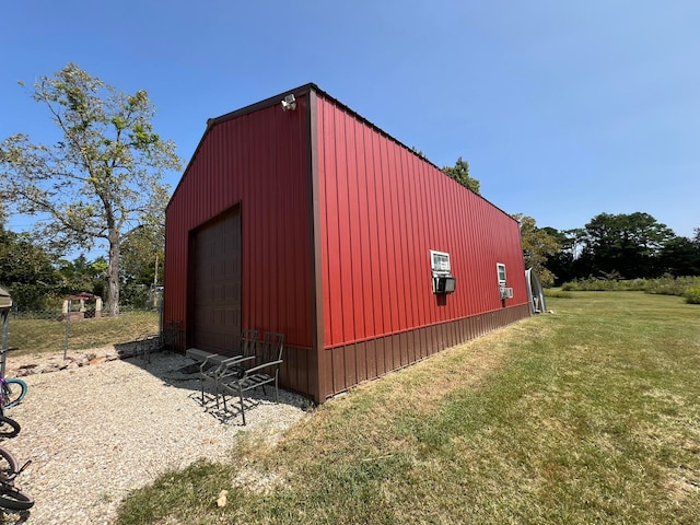 view of outbuilding with a garage and a yard