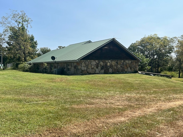 view of property exterior featuring cooling unit and a lawn